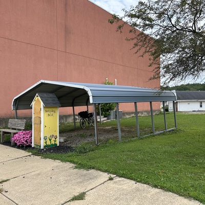 The steel carport will be replaced with a timber-frame pavilion this fall