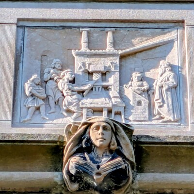 Gutenberg Printing Press Scene (circa 1440) in masonary relief; north side of Scheide House