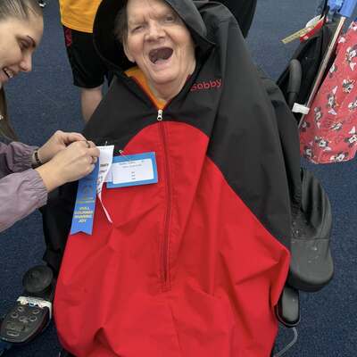 Bob gets his Special Olympics ribbon pinned by Margaret