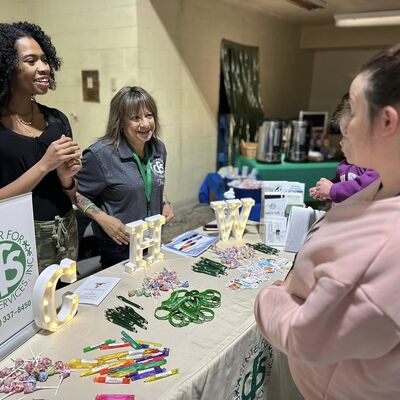 Trish and Imira greeting people at FCCA's Baby Shower event