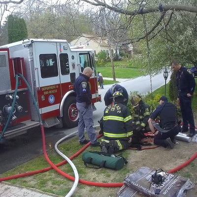 Emergency responders supply oxygen to a pet rescued from a house fire in Meadville