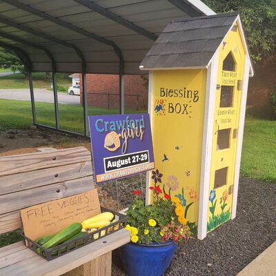 Our blessing box, along with an offering of free veggies grown in our community learning garden!