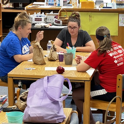 Storyhour moms enjoying time together and a break while the kids reading a story with Ms. Shanna.