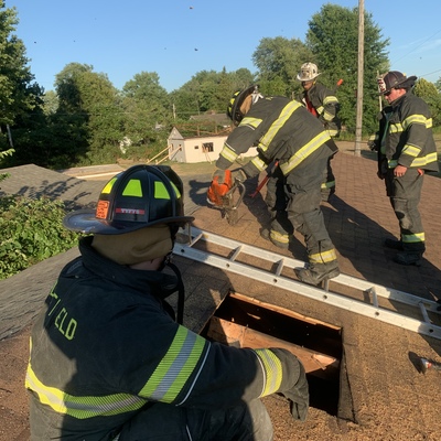 Firefighters ventilating a roof at a training with Conneaut Lake