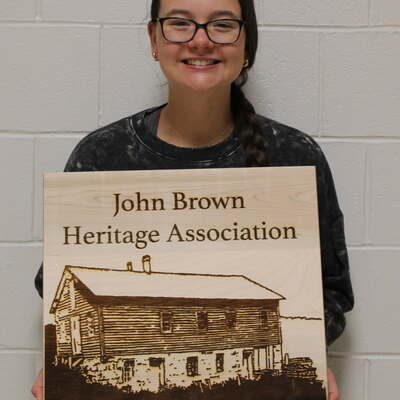 An engraved wooden sign for the Association, recently created by Samantha Stanford